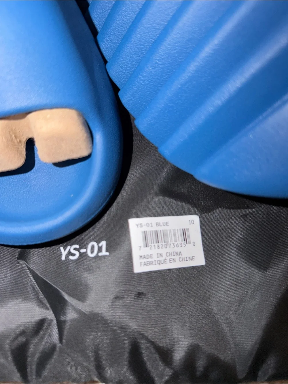 foam runner/slides inspired by Yeezy‎ designs. The bag says “YS-01,”